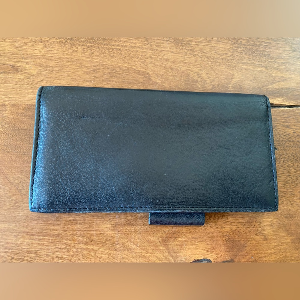 Leather checkbook cover with pen loop.